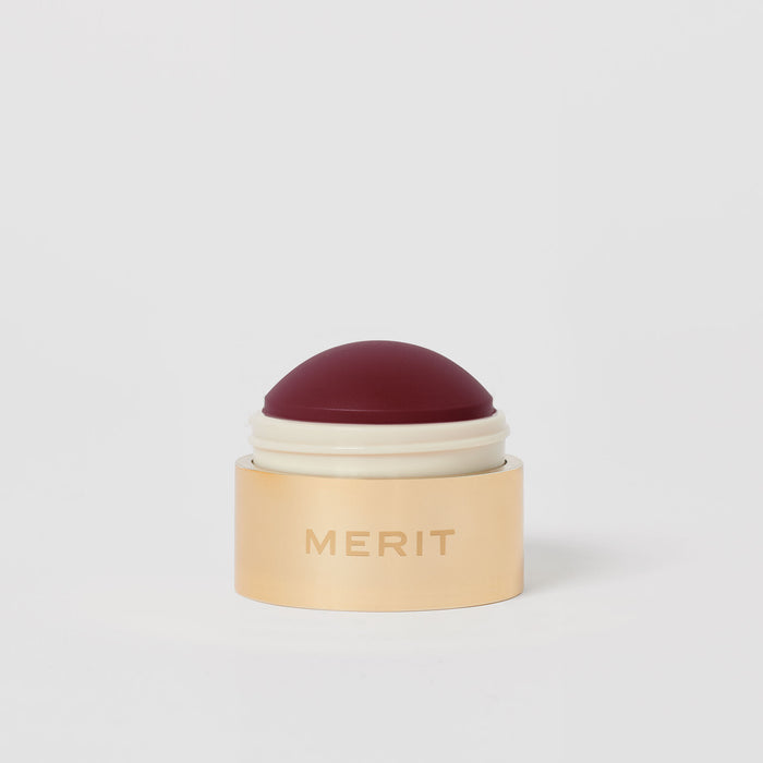Master || A cream blush balm by Merit Beauty in color Apres and gold body, awarded 'Best of Beauty' by Allure in 2022.