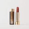 Antibes ||  A tube of lipstick in shade Antibes with a gold and brown cap next to its open container