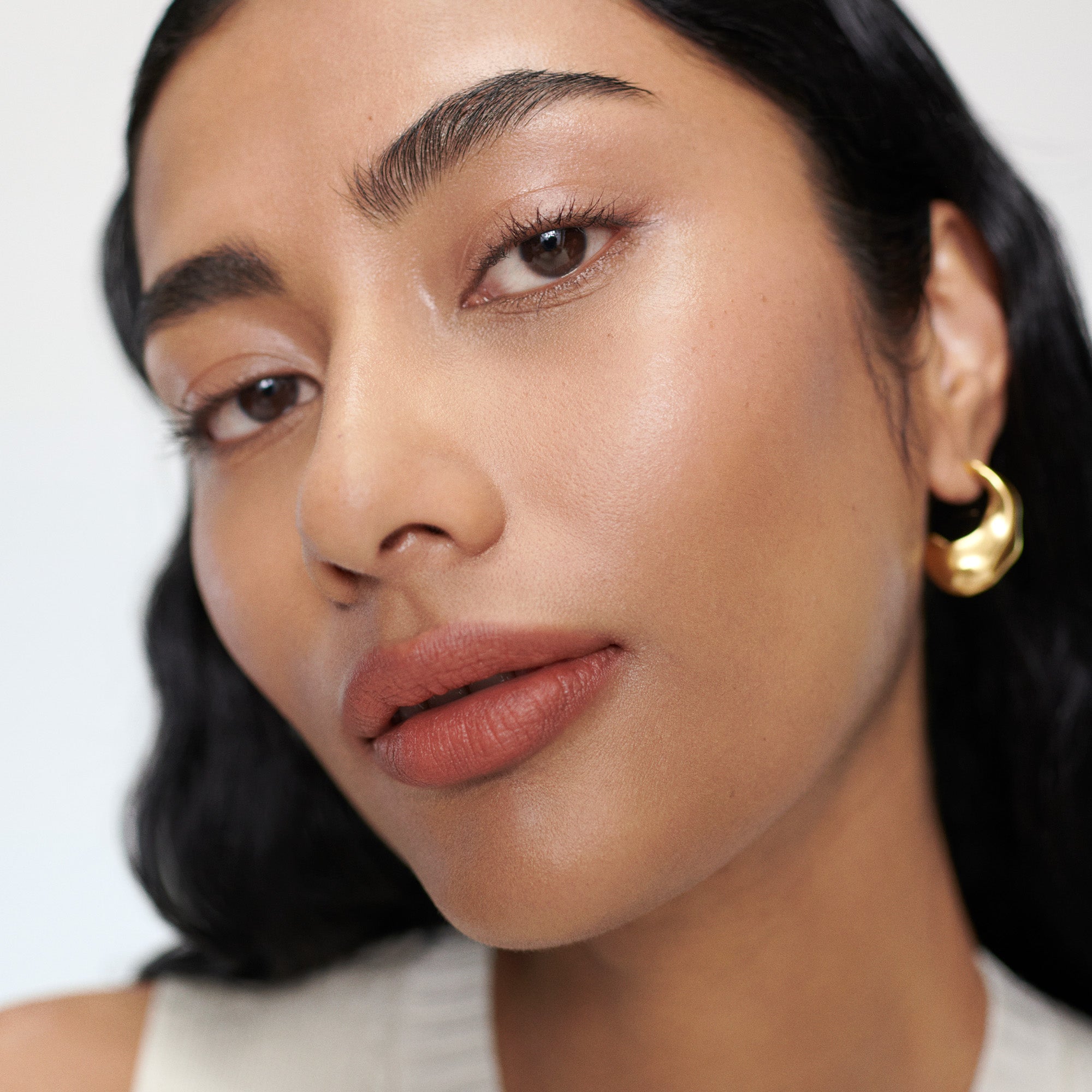 Shikin wears Signature Lipstick in shade Antibes