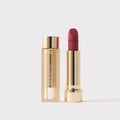 Master || Signature Lip Lightweight Lip Blush in Framboise next to its case.