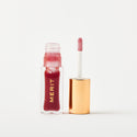 Master ||A bottle of Merit lip oil in shade Mapleton displayed next to its applicator. 