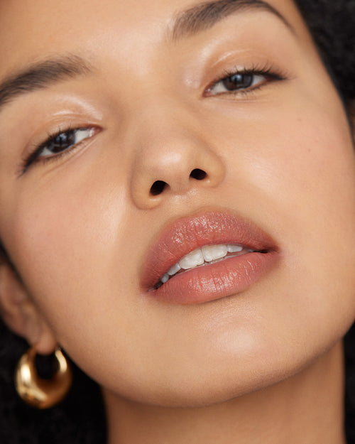 Image of model wearing Signature Lip in Ginger looking into the camera.