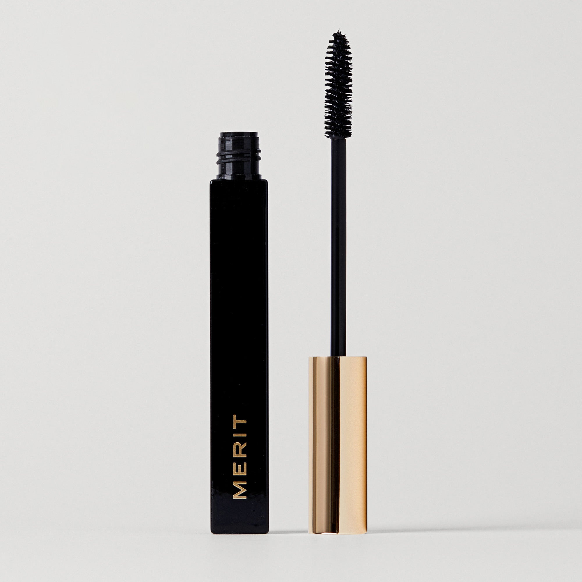 Master ||Clean lash mascara wand with black mascara is shown alongside a mascara tube 