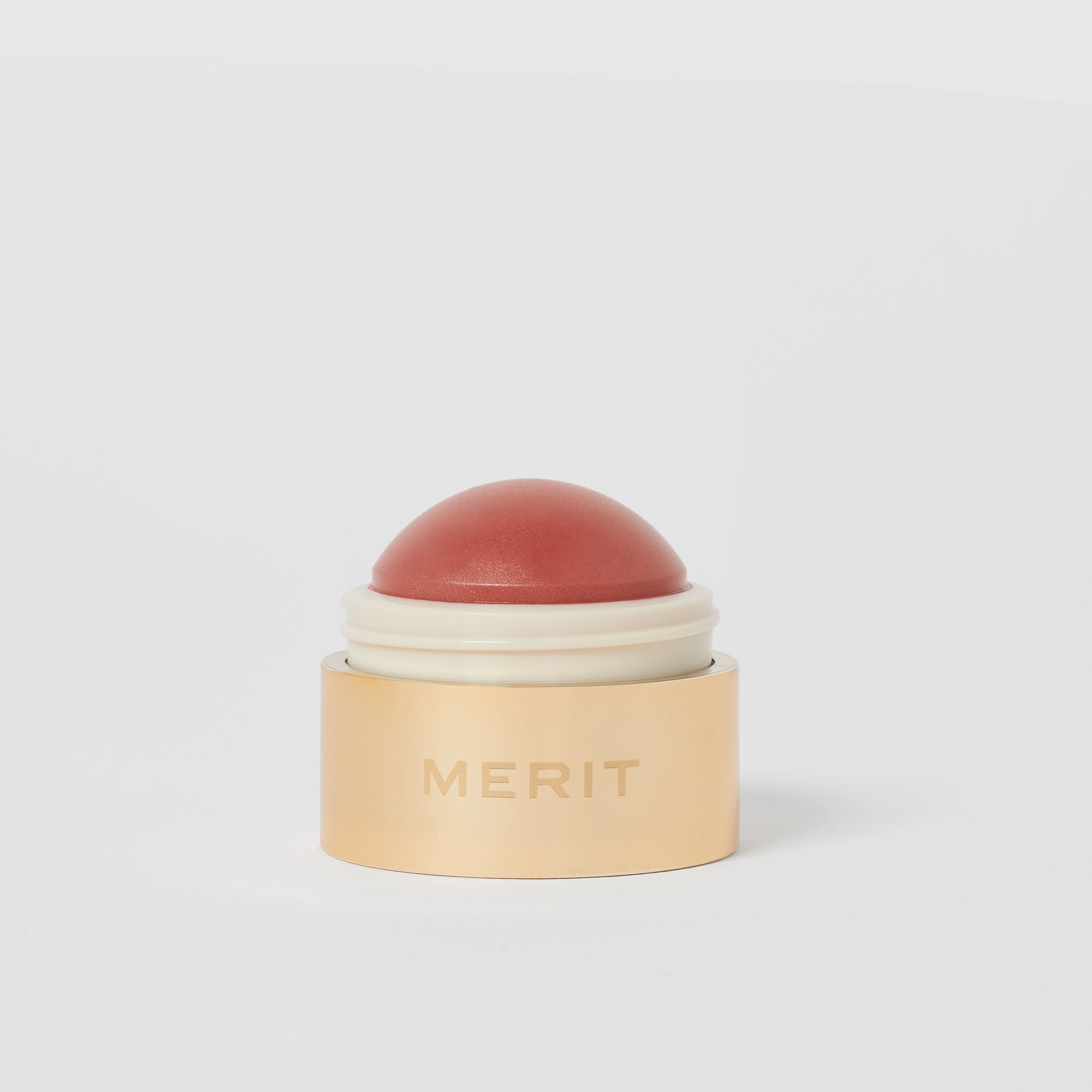 Master || A cream blush balm by Merit Beauty in color Beverly Hills and gold body