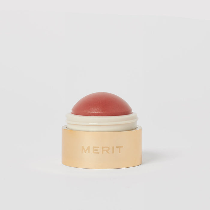 Master ||   A cream blush balm by Merit Beauty in color Beverly Hills and gold body