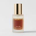 Master || skin care serum with dark and clear bi-phase liquid visible through the clear glass, branded 'MERIT', with a gold cap on the bottle.