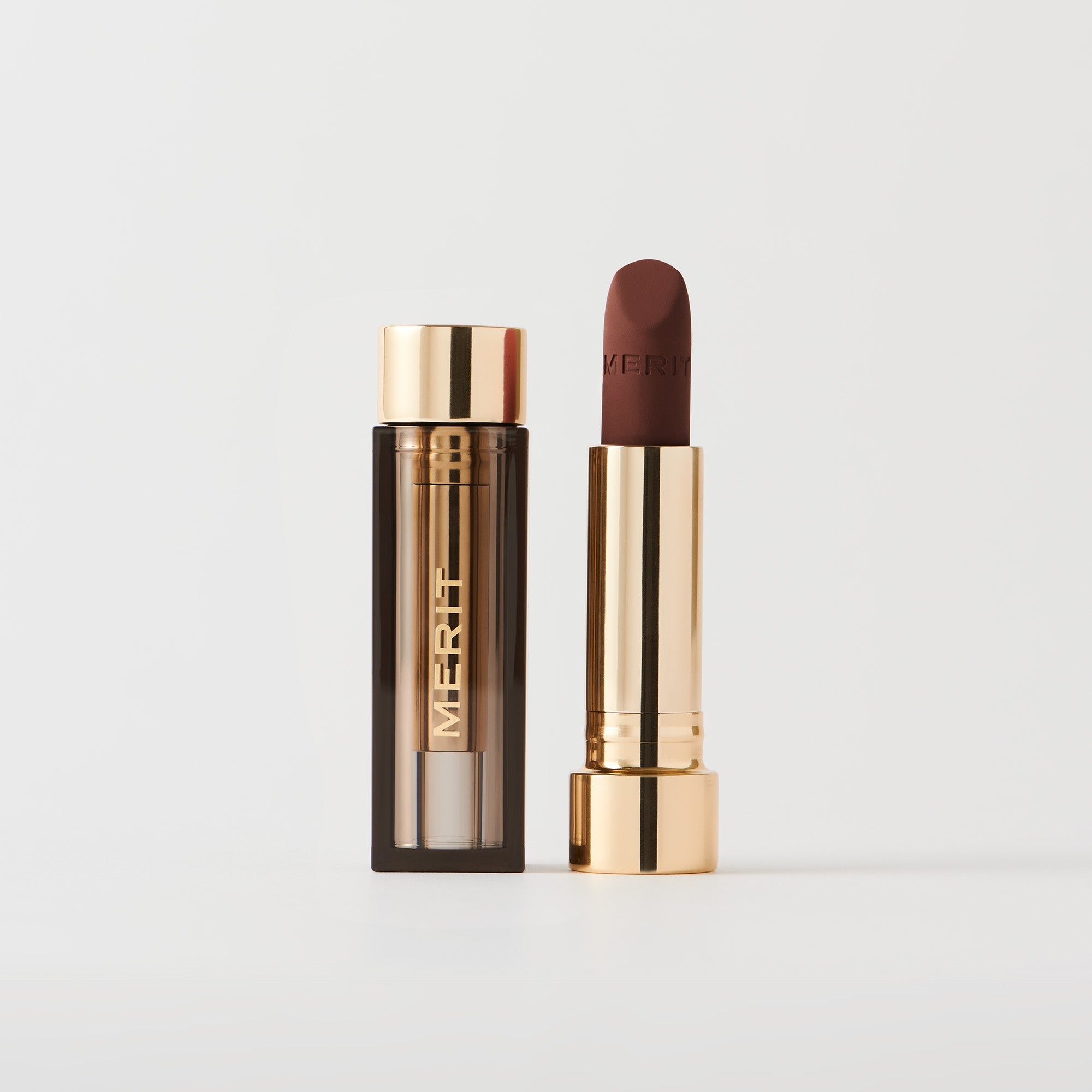 Master ||  A tube of lipstick in Equestrian with a gold and brown cap next to its open container
