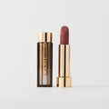 Master ||  A tube of lipstick in Maison with a gold and brown cap next to its open container