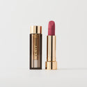 Master ||  A tube of lipstick in shade Sunday with a gold and brown cap next to its open container