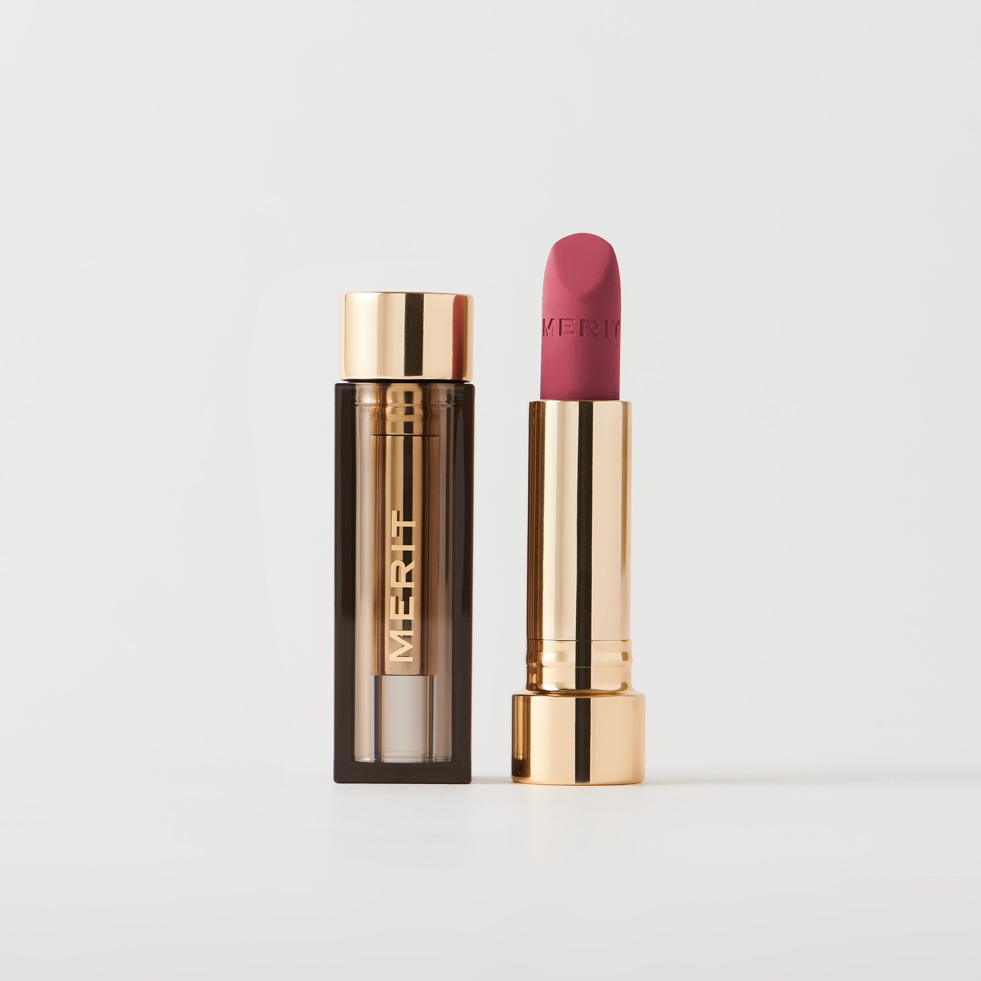 Master ||  A tube of lipstick in shade Sunday with a gold and brown cap next to its open container