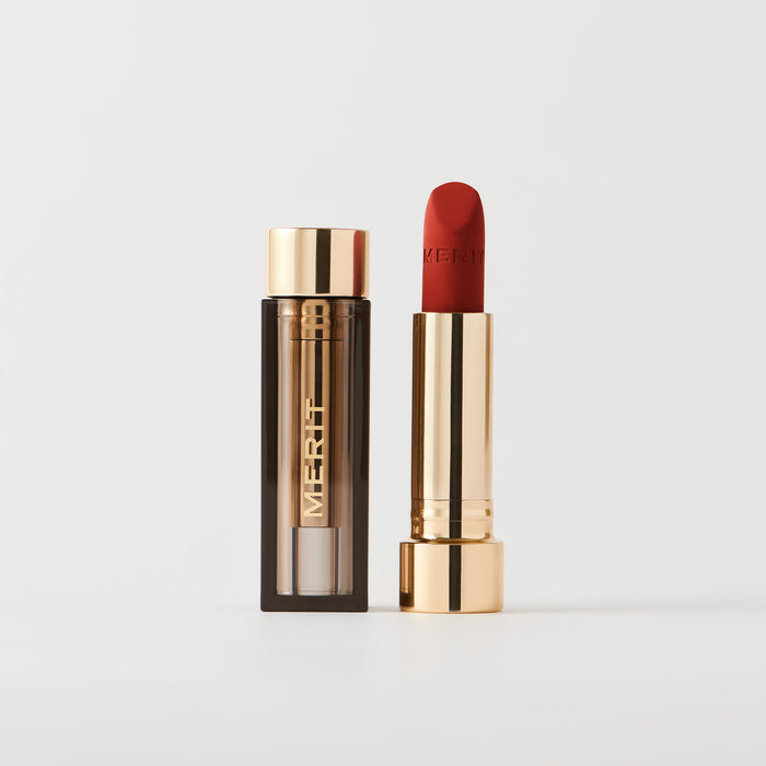 Master ||  A tube of lipstick in Vermillion with a gold and brown cap next to its open container