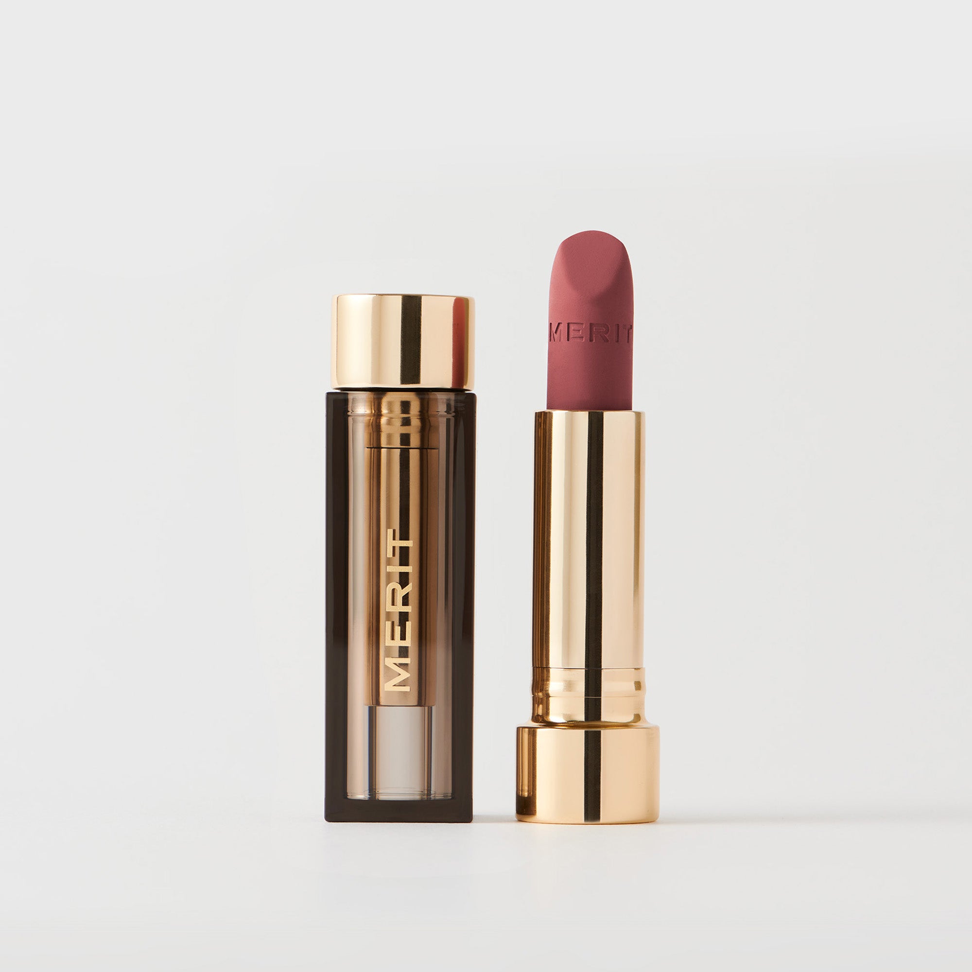 Master ||  A tube of lipstick in shade Classic with a gold and brown cap next to its open container