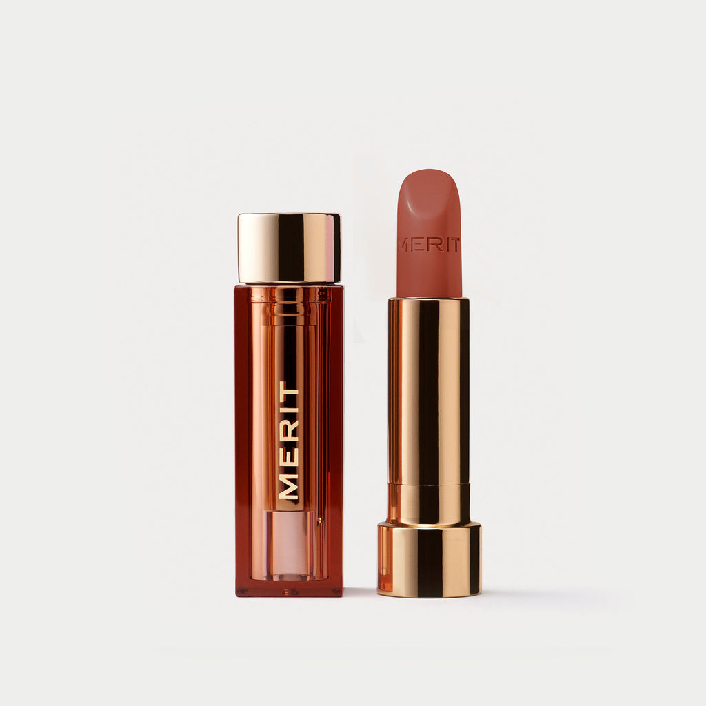 Master ||  A tube of lipstick in shade ginger with a gold and brown cap next to its open container