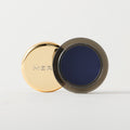 Master || A cream-to-powder eyeshadow by MERIT Beauty in Midnight.