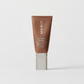 Master || A tube of MERIT brand mineral sunscreen with a sheer tint finish, providing broad spectrum 50 UVA/UVB protection, displayed against a white background. Shade 04