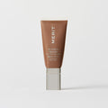 Master || A tube of MERIT brand mineral sunscreen with a sheer tint finish, providing broad spectrum 50 UVA/UVB protection, displayed against a white background. Shade 6