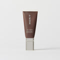 Master || A tube of MERIT brand mineral sunscreen with a sheer tint finish, providing broad spectrum 45 UVA/UVB protection, displayed against a white background. Shade 02