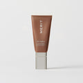 Master || A tube of MERIT brand mineral sunscreen with a sheer tint finish, providing broad spectrum 45 UVA/UVB protection, displayed against a white background.