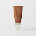 Master || A tube of MERIT brand mineral sunscreen with a sheer tint finish, providing broad spectrum 45 UVA/UVB protection, displayed against a white background. Shade 08