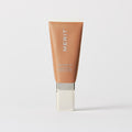 Master || A tube of MERIT brand mineral sunscreen with a sheer tint finish, providing broad spectrum 45 UVA/UVB protection, displayed against a white background. Shade 12