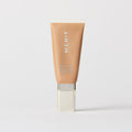 Master || A tube of MERIT brand mineral sunscreen with a sheer tint finish, providing broad spectrum 45 UVA/UVB protection, displayed against a white background. Shade 18