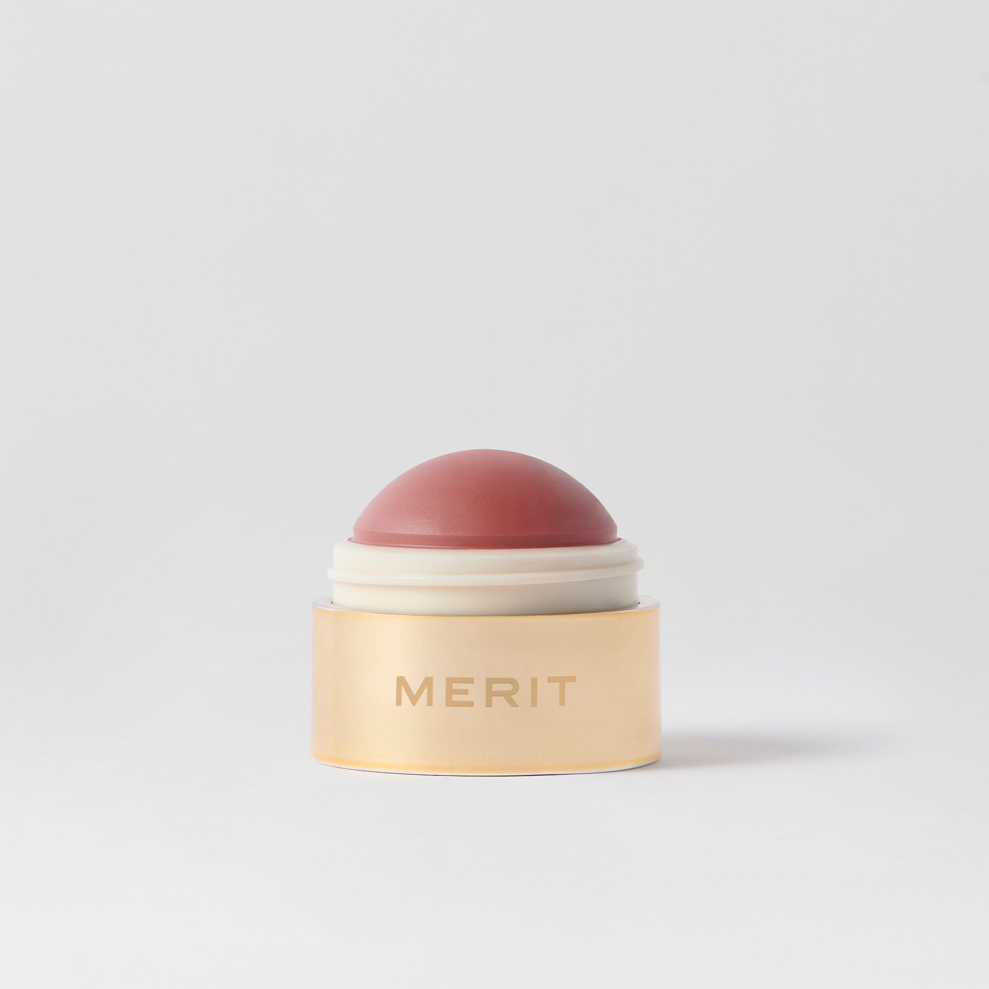 Master || A cream blush balm by Merit Beauty in color archival and gold body