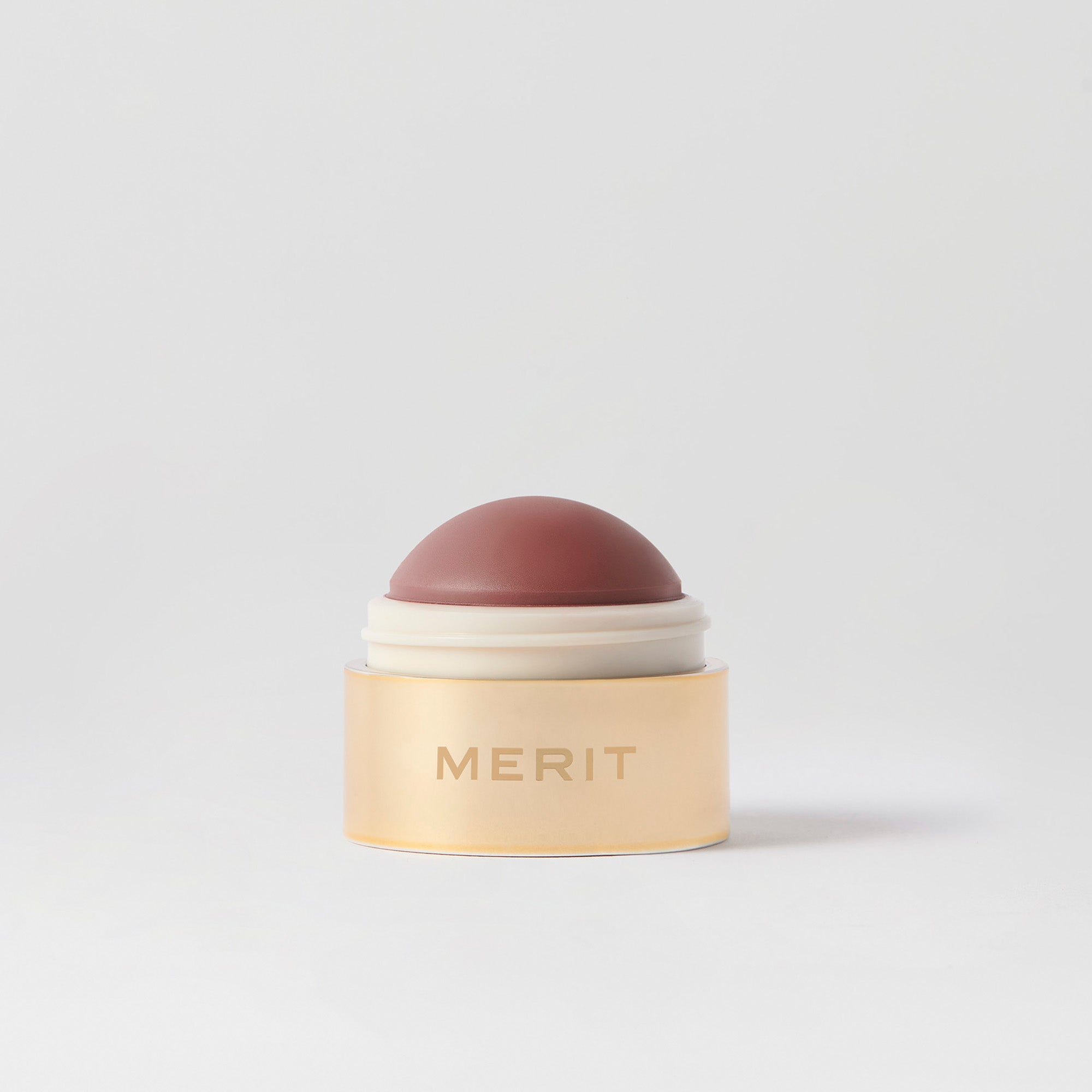 Master || A cream blush balm by Merit Beauty in color Bespoke and gold body, awarded 'Best of Beauty' by Allure in 2022.