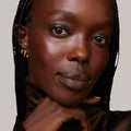 Persimmon | face::rich |  Model is wearing Flush Balm in shade Persimmon.