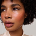 Persimmon | face::deep | Model is wearing Flush Balm in shade Persimmon.