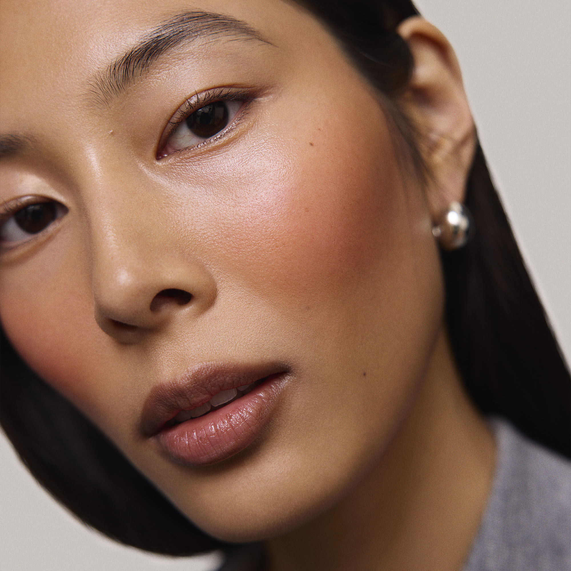 Persimmon | face::medium |  Model is wearing Flush Balm in shade Persimmon