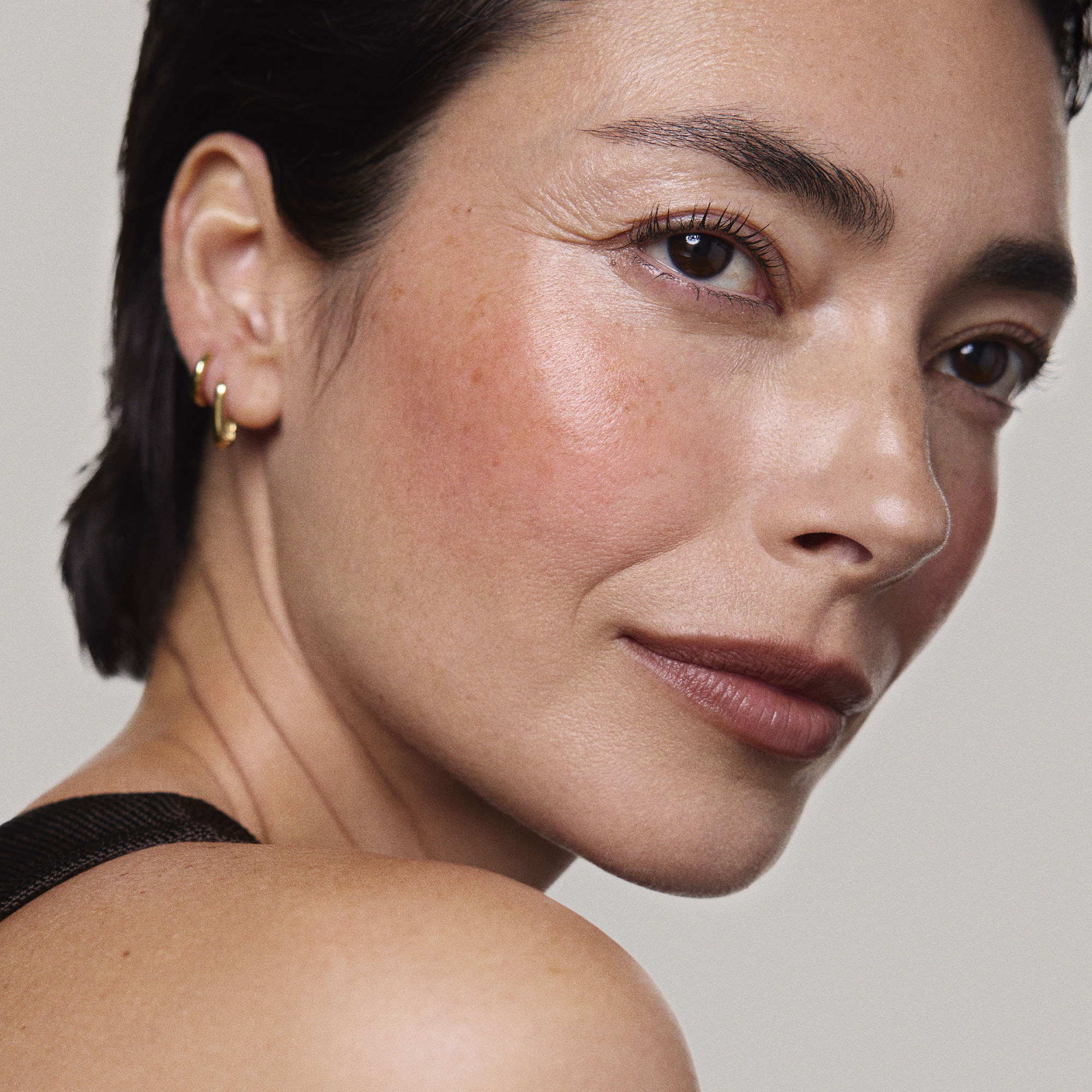 Persimmon | face::light |  Model is wearing Flush Balm in shade Persimmon