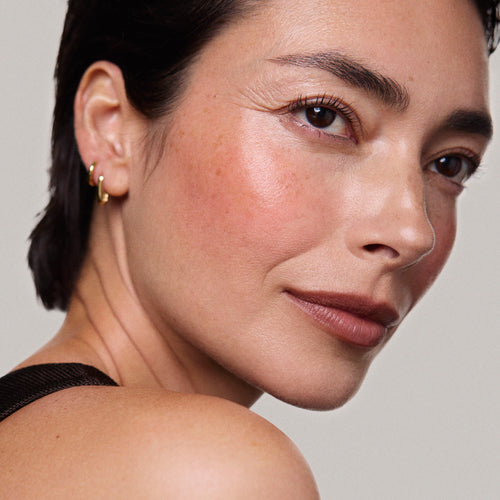 Persimmon | face::light |  Model is wearing Flush Balm in shade Persimmon