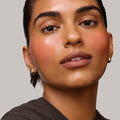 Persimmon | face::medium |  Model is wearing Flush Balm in shade Persimmon.