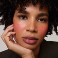 Rouge | face::deep | Model is wearing Flush Balm in shade Rouge.