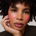 Rouge | face::deep | Model is wearing Flush Balm in shade Rouge