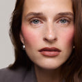 Rouge| face::fair | Model is wearing Flush Balm in shade Rouge.