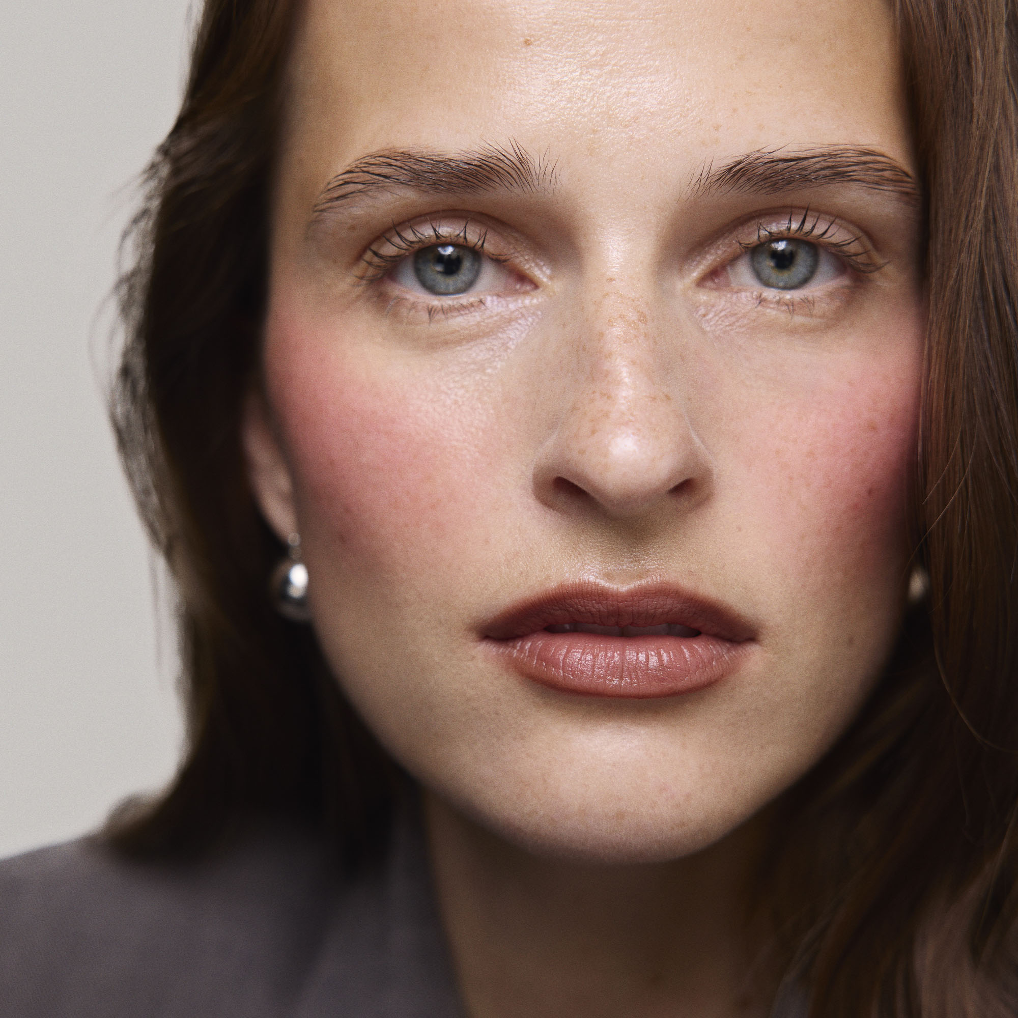 Rouge| face::fair | Model is wearing Flush Balm in shade Rouge