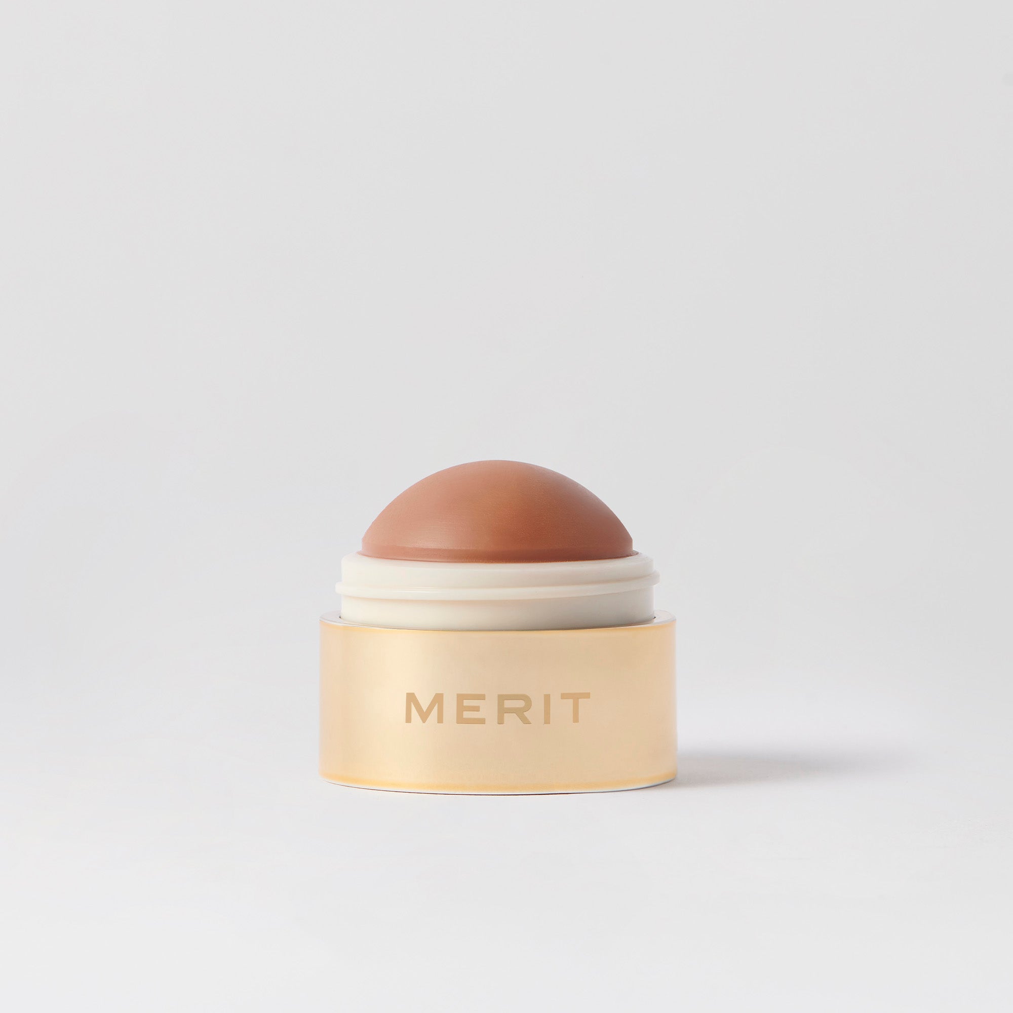 Master || A cream blush balm by Merit Beauty in color Terracotta and gold body, awarded 'Best of Beauty' by Allure in 2022.