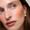 Master || Model is wearing Flush Balm in shade Terracotta.