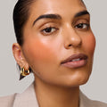 Master || Model is wearing Flush Balm in shade Terracotta.