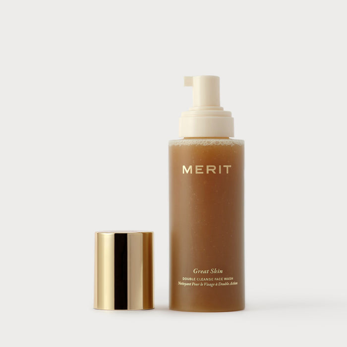 Master || Cleanser bottle shaken with pump and gold cap on a white background, featuring the brand 'MERIT'.