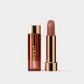  Master || A tube of lipstick in shade Slip with a gold and brown cap next to its open container
