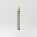 Master || Travel Bottle of Retrospect perfume with a gold sprayer and MERIT written on the front