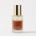 Master || Two bottles of skin care serum with dark and clear bi-phase liquid visible through the clear glass, branded 'MERIT', with a gold cap on each bottle.