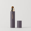 Master || A stick concealer product with the brand name 'MERIT' written on it, with the cap removed, showing the product in a shade of medium skin tone.