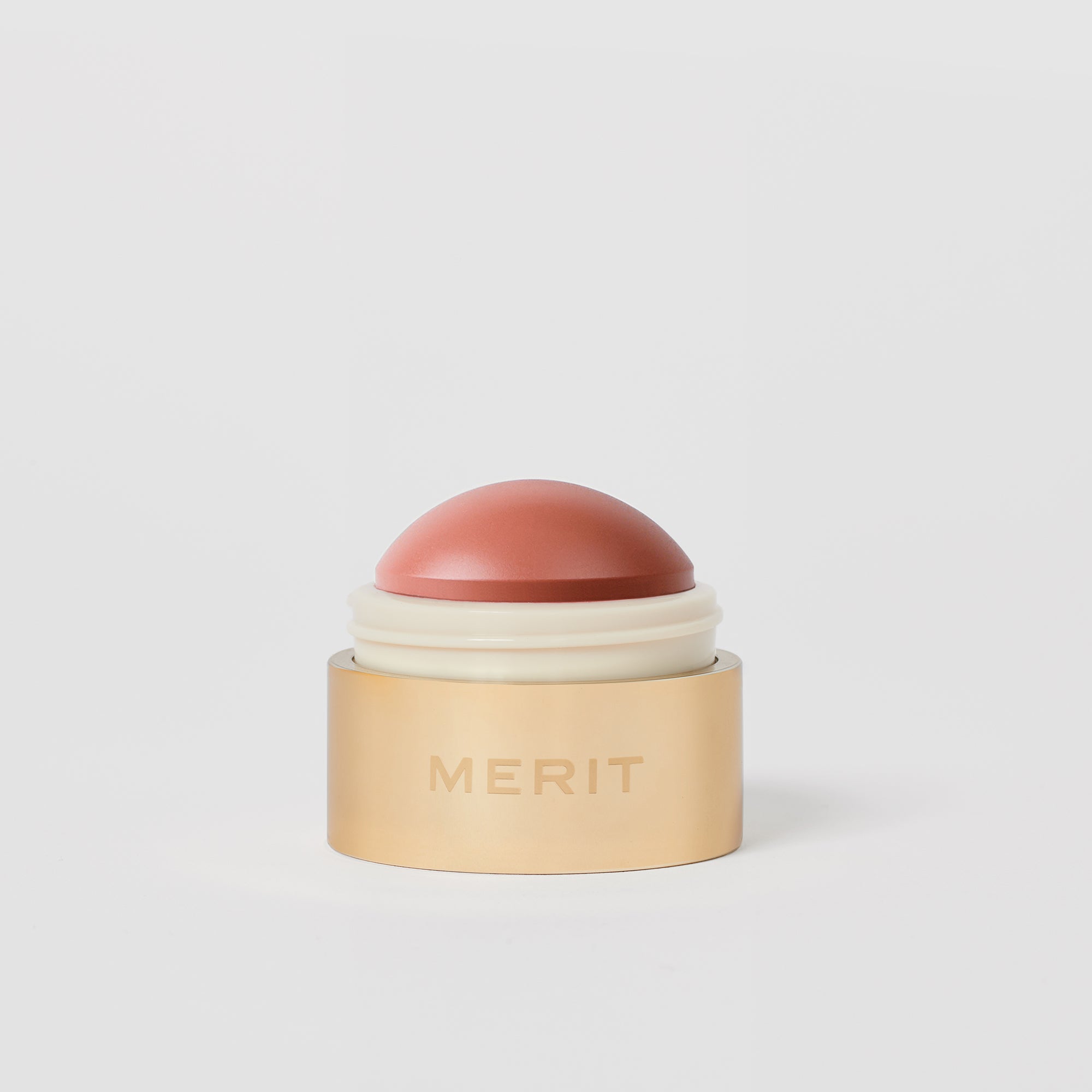 Master ||  A cream blush balm by Merit Beauty in color Beverly Hills and gold body